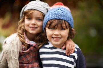 Obraz premium Kids, love and siblings portrait in a park for travel, adventure or bonding on autumn journey in nature. Family, face and children hug in a forest for explore, playing or fun games in Canada outdoor