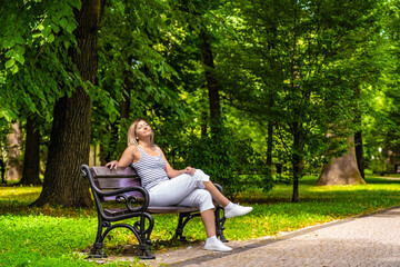 Mid-adult beautiful woman resting in city park