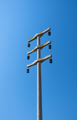 Concrete electric pole made for high voltage lines. porcelain insulators.