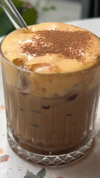 Vietnamese Egg Coffee. Paleo, Dairy-free keto coffee latte drink with sweet sugared Whipped yolks Top view a cup of Giang egg coffee on wood background. Vietnamese coffee. Eggs are beaten with coffee