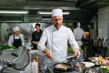 The chef cooks in a professional kitchen