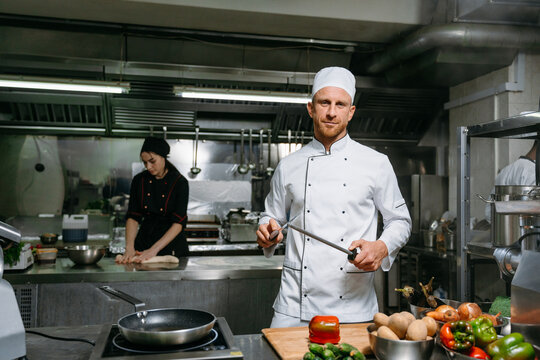 Portrait of a man sharpening a knife