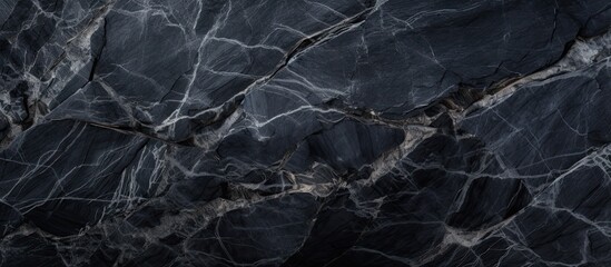 A detailed closeup of a black marble texture with intricate patterns resembling a dark landscape,...