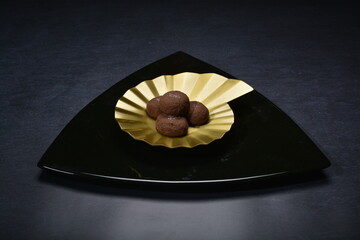 baked luxury dark chocolate coffee cocoa cookies with chocolate chip Himalaya rock salt and gold black plate gold fork knife on dark background pastry dessert halal vegan party food menu gluten free