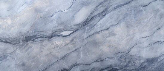 A close up of a grey marble texture resembling a cloudy sky with cumulus clouds forming an electric blue pattern on a freezing mountain range landscape - Powered by Adobe