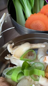 Korean foods served on a dining table. Perfect article, or any cooking contents. traditional hot pot combo, sweet garlic, and beef slices. It is very popular in sichuan