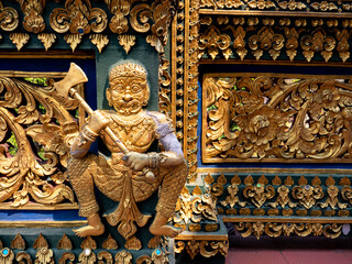 Golden Giant Statue Holding a Axe Sitting