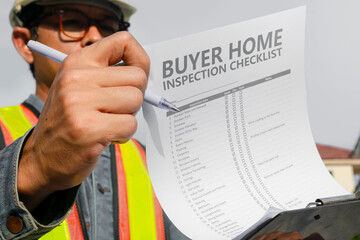 The home inspector or engineer checks the building structure and house construction specifications....