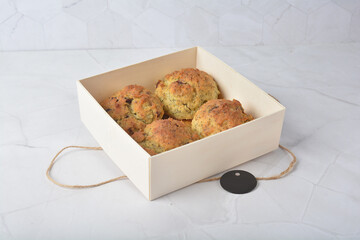 gourmet freshly bake golden Texas pope earl grey tea honey biscuit bun cake scone milk butter bread in square bento wood box on white marble table rose gold fork knife pastry halal dessert vegan menu