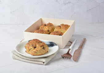 gourmet freshly bake golden Texas pope earl grey tea honey biscuit bun cake scone milk butter bread in square bento wood box on white marble table rose gold fork knife pastry halal dessert vegan menu