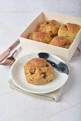 gourmet freshly bake golden Texas pope earl grey tea honey biscuit bun cake scone milk butter bread in square bento wood box on white marble table rose gold fork knife pastry halal dessert vegan menu