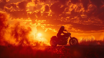 Obraz na płótnie Canvas Dramatic silhouette of a biker against a blazing sunset sky.