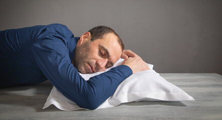 Obraz premium Tired caucasian man sleep at workplace.