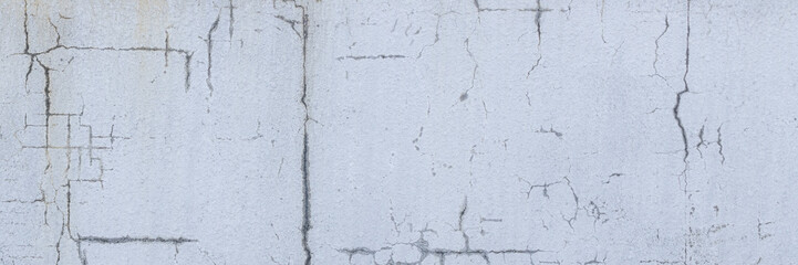 Old wall with cracked plaster. Weathered rough surface. Wide panoramic texture for background and design.