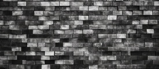 A monochrome photo featuring a rectangular pattern of grey brickwork. The bricks add texture to the buildings facade, showcasing the beauty of this building material