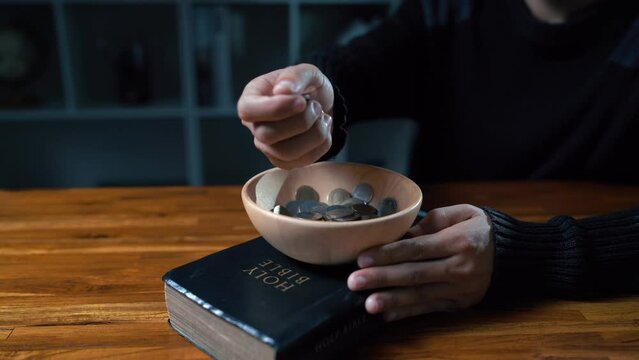 Close up hands people church congregants placing Money on an offering basket.