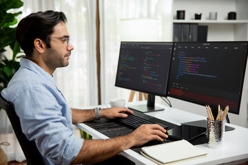 Smart IT developer working software development coding with creating application program update version online website on data's company system two computer code pc screen at modern office. Surmise.