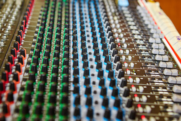 Volume and equalization controls on professional mixing console