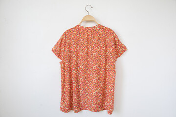 Summer blouse is clothes hanger on white background.