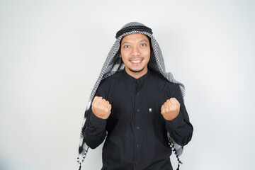Asian muslim man full of enthusiasm celebrating and confidence wearing Arabic turban sorban...