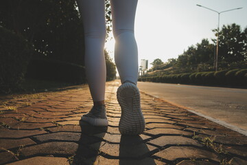 Young fitness woman runner stretching legs before run on city - obrazy, fototapety, plakaty