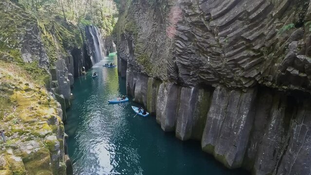 Landscape Takachiho Gorge is River canyon with waterfalls over sheer basalt cliffs viewable from rented boats and a paved path in Takachiho Miyazaki Kyushu Japan - Footage Clip Travel Nature