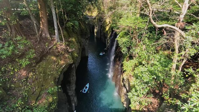 Landscape Takachiho Gorge is River canyon with waterfalls over sheer basalt cliffs viewable from rented boats and a paved path in Takachiho Miyazaki Kyushu Japan - Footage Clip Travel Nature
