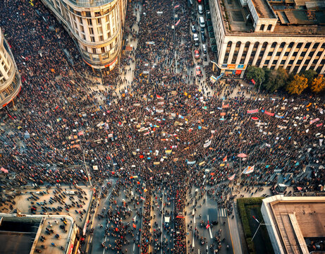 Aerial view of a massive protest taking place in a big avenue as citizens demand improvements to their government.