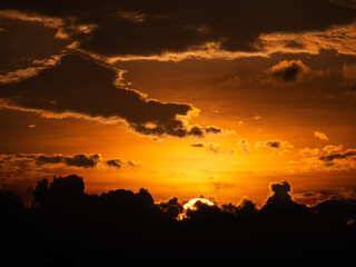 Fototapeta na wymiar Yellow Sunset above The Dark Clouds
