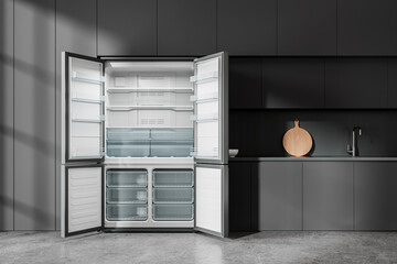 Dark home kitchen interior with cooking cabinet and empty opened fridge