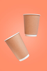 paper cups on peach pink background, ecology concept
