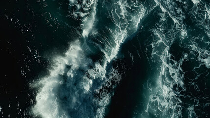 Aerial view of tumultuous sea waves churning in the ocean.