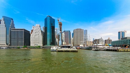 New York skyline and sea, air, space museum with an aircraft carrier along the shore of the Hudson river under dark grey skies