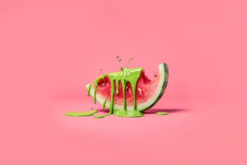 Keuken spatwand met foto A watermelon slice dripping with green paint on a pink background,  minimal summer concept  in the style of pop art © ALL YOU NEED studio