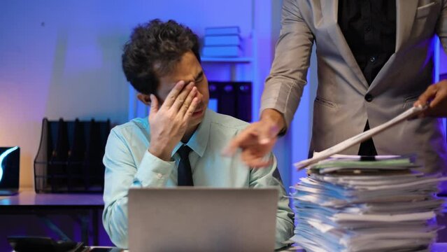 Boss is giving job recommendations to employee. Businessman working overtime in the office. Man employee are stressed due to excessive workload and overwork.
