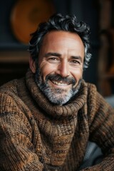 Obraz premium Handsome smiling, happy and pleased stoic man with positive vibes. Portrait of a joyful young man with beautiful hair and fashionable clothes.