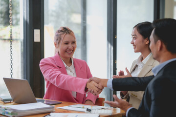 Business colleagues shaking hands in meeting. Business agreement and teamwork concept.