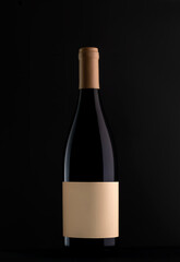 Red wine bottle with blank label on black background. Easily apply your custom design on the label. Mockup