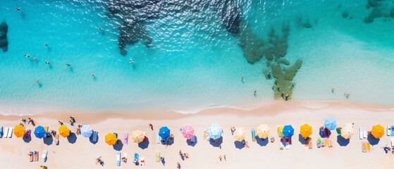 Aerial view of sandy beach with colorful umbrellas 
