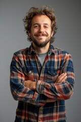 Obraz premium Handsome smiling, happy and pleased stoic man with positive vibes. Portrait of a joyful young man with beautiful hair and fashionable clothes.