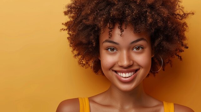 In a beige background, a woman blow-dries curly afro hair with a blow dryer, using home beauty products to style her hair, smiling