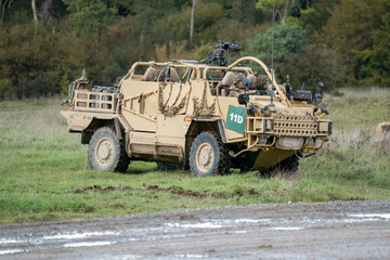 Obraz premium British army Supacat Jackal 4x4 rapid assault, fire support and reconnaissance vehicle, in action on a military exercise, Wilts UK