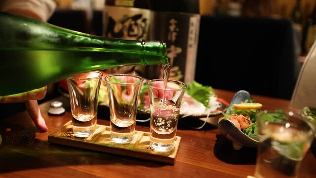 Pouring Sake into Glasses