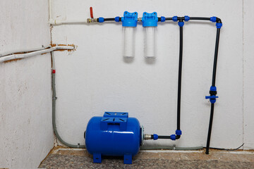Residential water cleaning system using string wound polypropylene sediment filter cartridges.