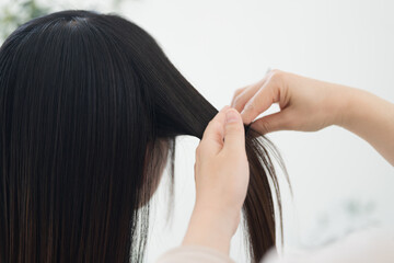 Close-up of the back of the head showing hair set, cut coloring, etc. at a beauty salon, without...