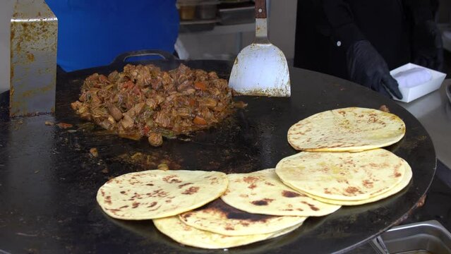 Meat doner kebabs being prepared in a fast food restaurant.