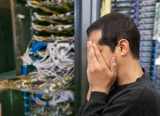 Profile shot of an IT technician having difficulty repairing a computer in a data center of AI.