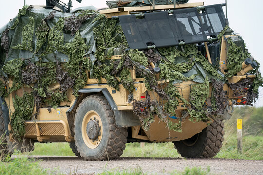 British army Supacat Jackal 4x4 rapid assault, fire support and reconnaissance vehicle with camouflage, in action on a military exercise, Wilts UK