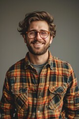 Obraz premium Handsome smiling, happy and pleased stoic man with positive vibes. Portrait of a joyful young man with beautiful hair and fashionable clothes.