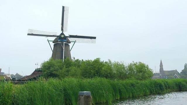 Paisaje R&iacute;o Zaan con molino de viento centenario y la ciudad holandesa de Zaandijk